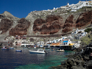 Port of Ammoudi below the clifftop village of Oia on the volcanic island of Santorini in the Greek...