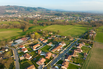 Aerial view of residential houses in green suburban rural area