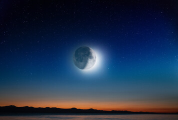 Fototapeta na wymiar Full moon over the sea. Full moon on the starry sky .