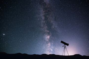 Telescope silhouette on the background of the bright milky way galaxy. © Inga Av