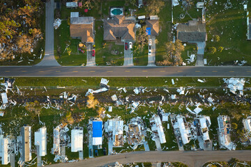 Badly damaged mobile homes after hurricane Ian in Florida residential area. Consequences of natural disaster © bilanol