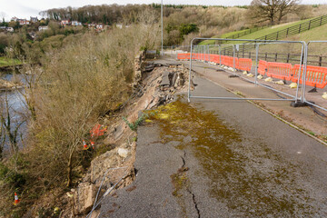 Local road B5605 Newbridge Wrexham Wales after part of the road collapsed in to the river Dee...