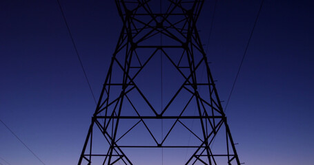 Image of electricity poles at dusk