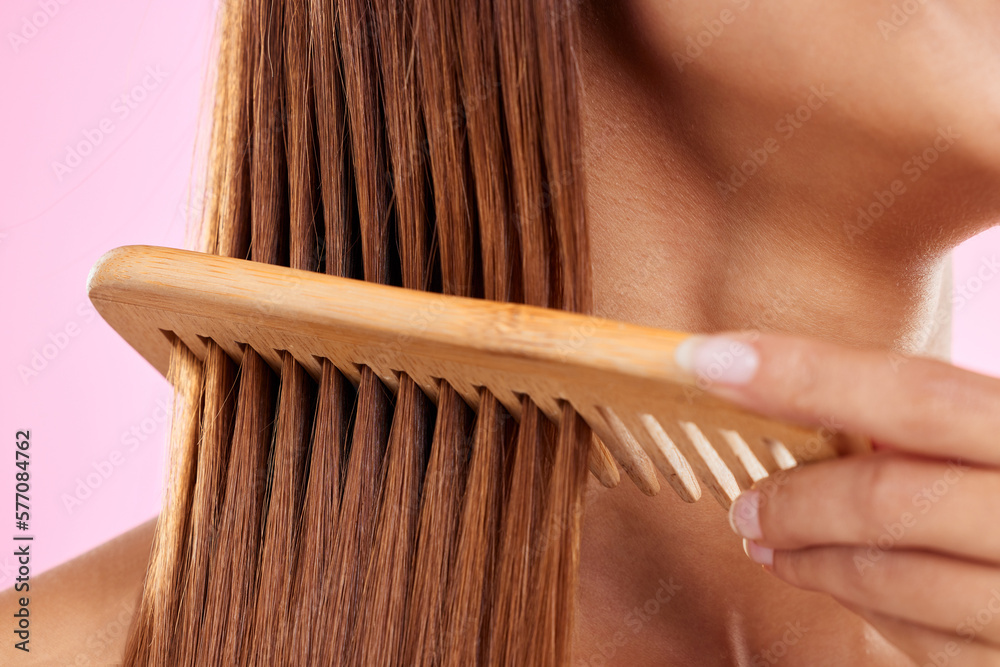 Canvas Prints Beauty, comb and bamboo with hair of woman for health, salon and satisfaction in studio. Wellness, keratin and natural with girl model and self care for cosmetics, brush and shine on pink background