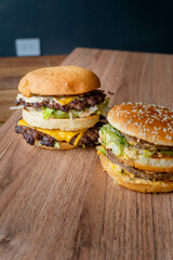 two burgers on a table comparative