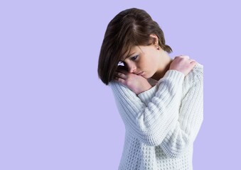 Caucasian shy woman hugging herself against copy space on purple background