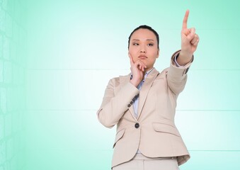 Thoughtful asian businesswoman touching futuristic screen against copy space on green background