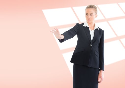 Caucasian businesswoman holding an invisible object against copy space on pink background