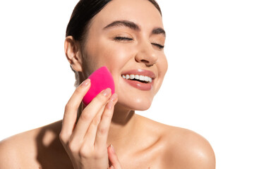 cheerful young woman with natural makeup holding pink beauty sponge isolated on white.