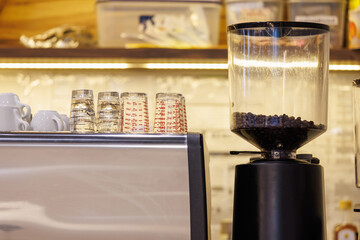 grinder coffee machine. Coffee beans inside the machine hopper of coffee shop.