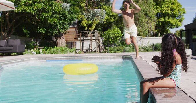 Happy biracial father and daughter spending time at pool together