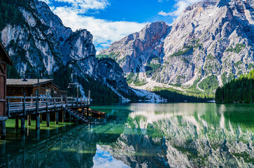 Lake surrounded by the mountains of the Italian alps. Fabulous views, magnificent mountains and lake. Free space for inscription text poster on backdrop nature Lake Braies emerald clear water.