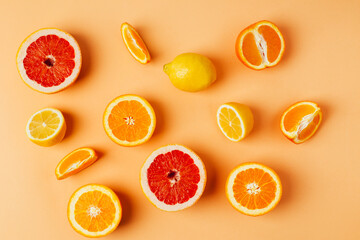 top view of orange grapefour and lemon citrus fruits on yellow background