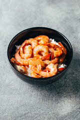 close-up of rice with fried shrimp on a gray background