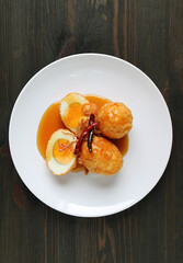 A Plate of Thai Famous Homemade Dish, Kai Look Keuy or Son In Law Eggs on Wooden Background