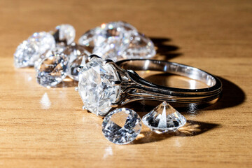pile of diamonds with a diamond ring, on the gemologist's table