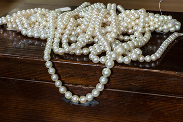 pearl necklaces placed on the wooden box