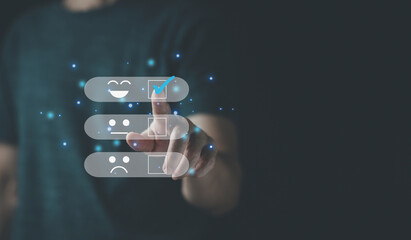 Close up Man hand choosing happy smile face icon on virtual screen to feedback rating and positive customer review experience  of product and service concept, Customer and business satisfaction.