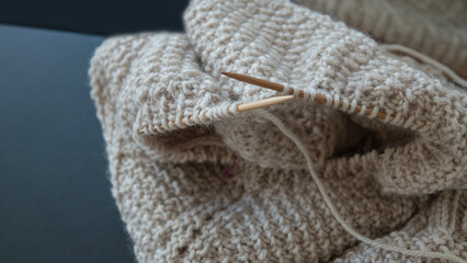 Knitting wool and sticks in close up.  Selective focus and shallow depth of field.