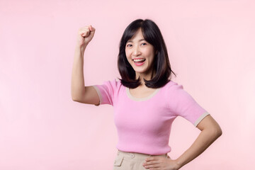 Portrait young asian woman proud and confident showing strong muscle strength arms flexed posing, feels about her success achievement. Women empowerment, equality, healthy strength and courage concept