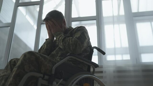 Military man with disability having hard times, feeling lonely in a hospital