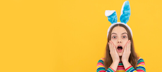 surprised easter kid girl in rabbit bunny ears smiling on holiday. Easter child horizontal poster. Web banner header of bunny kid, copy space.