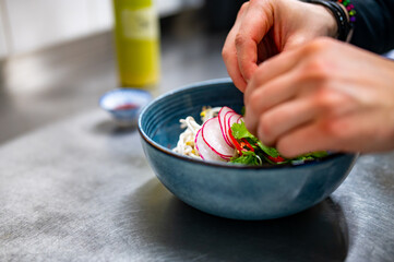 Close up of chef's hands cooking asian pho bo soup on restaurant kitchen