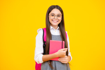 Schoolgirl with copy book posing on isolated background. Literature lesson, grammar school. Intellectual child reader.