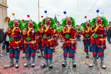 Basel Fasnacht, street costume carnival with flutes, drummers and confetti, people and children in...