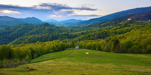 Fototapeta na wymiar stunning sunset over the rural mountain valley. carpathian countryside scenery in spring