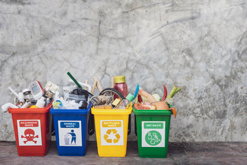 The concept of waste classification for recycling. Collection of waste bins full of different types...