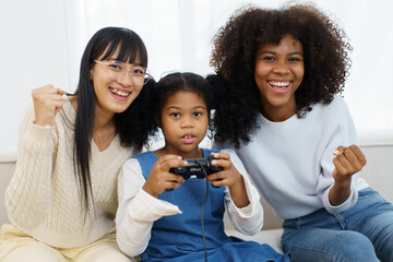 Concept of diversity in ethnic people spending a time together in a weekend. A diverse group and generation people relaxing and playing a video game together in living room.