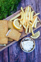   Allasca Pollock Fish  Bites in a crispy Tempura  Batter.Fish and chips .Close up of   crispy breaded  deep fried fish fingers with breadcrumbs s erved with remoulade sauce and  lemon