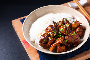 Food concept Asian sweet Glazed Pork and rice on black slate stone background with copy space