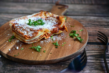   Delicious Home made  ketogenic Lasagna bolognese  with minced meat,tomato sauce and spinach  on a wooden rustic  background.Home made  keto diet italian meal