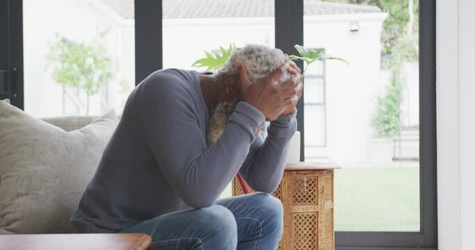Video of sad african american senior man with walking stick