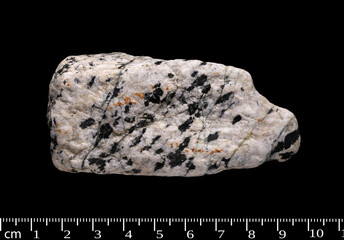 Syenite stone, igneous rock, isolated on black background 