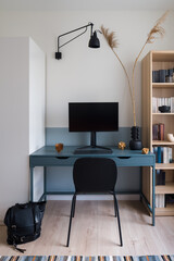Stylish blue desk in simple study room