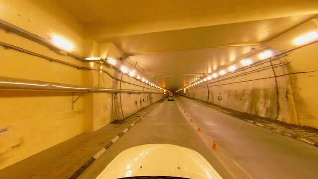 Driving Through the Tunnel: A Cinematic Journey experience of driving inside a long and winding tunnel, illuminated by a symphony of dazzling lights