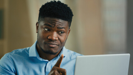 Angry annoyed man african businessman boss talk in video conference use computer arguing conflict...