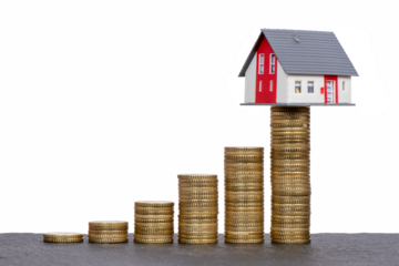 isolated stacked coins in form of chart with model home