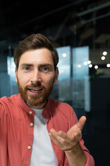 Close-up photo. Young businessman, freelancer, programmer conducts a video conference on a video...