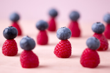 Creative blueberries on top raspberries closeup, Creative fruits.	