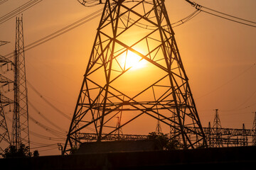high voltage electricity python and transmission line, power and energy at sunset