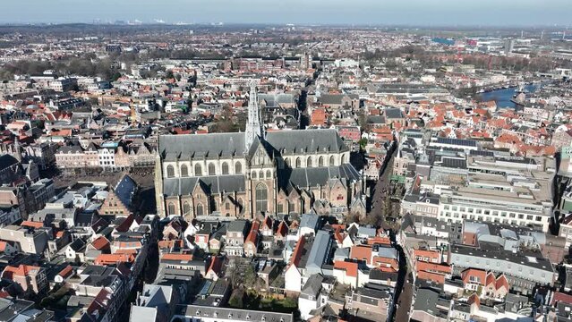 Soar above the iconic Grote Kerk, capturing its intricate spire and stunning architectural details.
