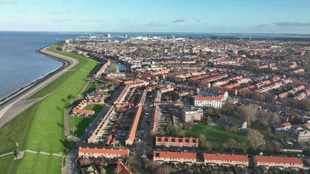 Marvel at the natural beauty of Den Helder's sand dunes and rugged coastline, as the drone captures breathtaking sea views.