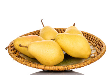Several ripe organic yellow pears on a ceramic dish, close-up isolated on white.
