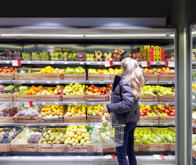 Woman buying fruits and vegetables at the market