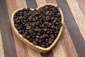 coffee beans in heart-shaped tra,y representing love of coffee