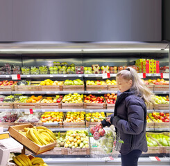 Woman buying fruits and vegetables at the market